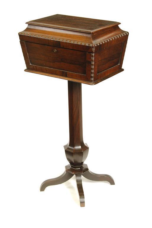 Appraisal: A rosewood sarcophagus shape pedestal sewing box