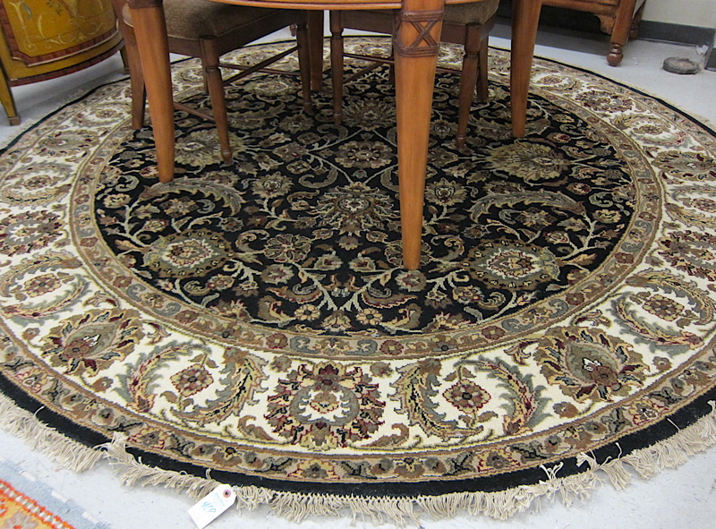 Appraisal: ROUND ORIENTAL CARPET Indo-Persian overall floral decoration on black ground