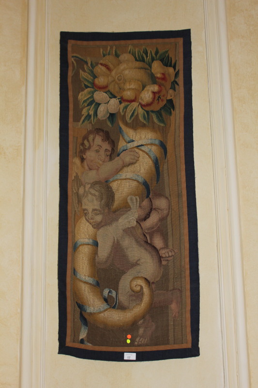 Appraisal: A pair of thC tapestry panels depicting cherubs within cornucopia