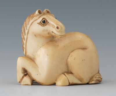 Appraisal: A Carved Ivory Netsuke of a Horse Depicting a recumbent