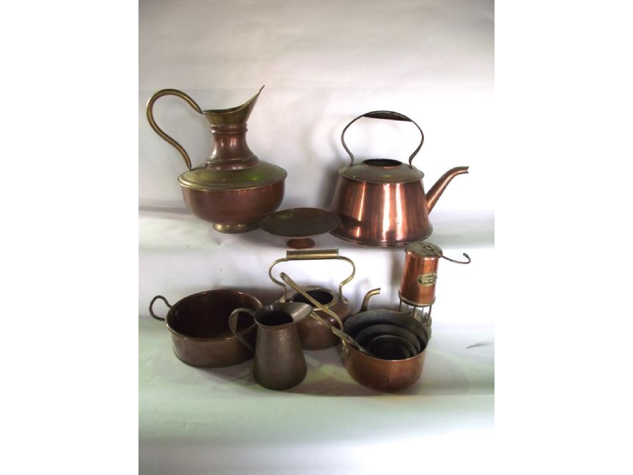 Appraisal: A selection of copper wares to include five graduating lined