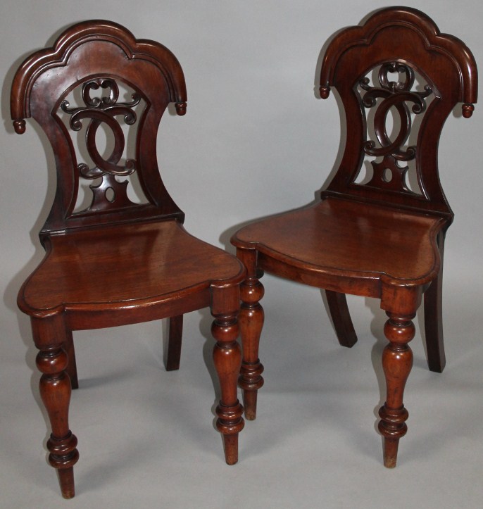 Appraisal: A pair of mid- thC mahogany hall chairs each with