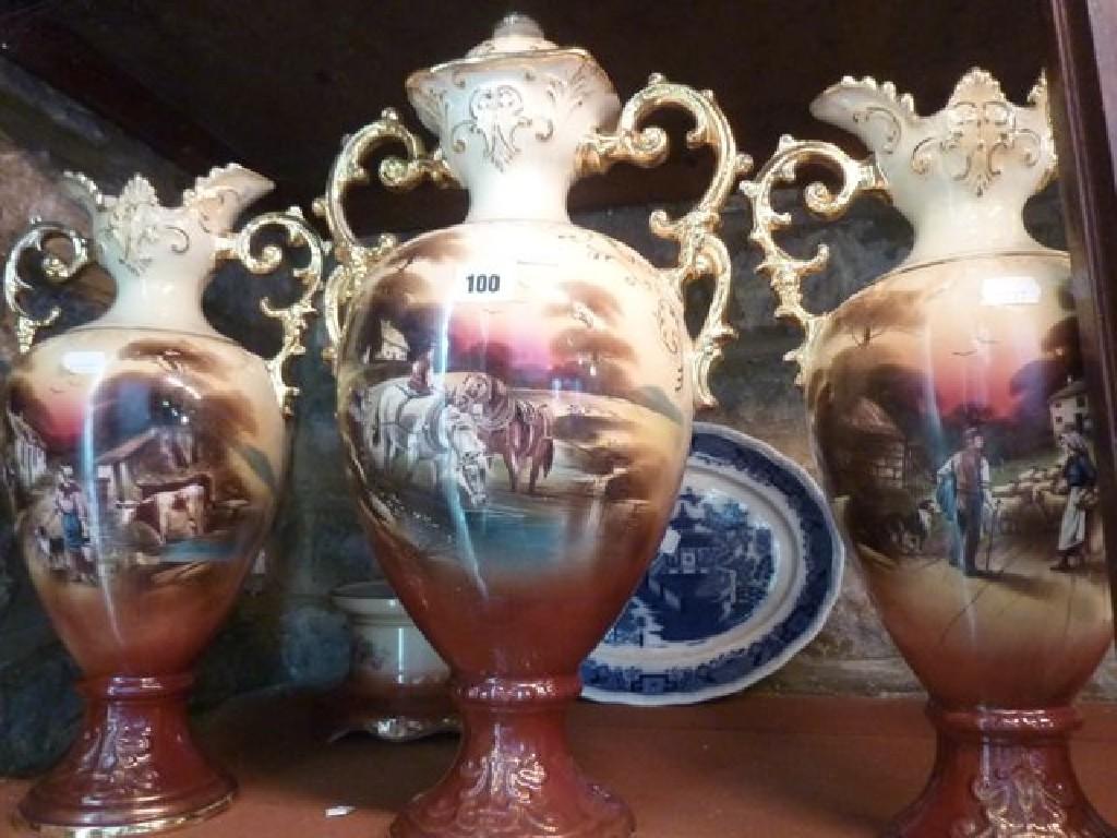 Appraisal: Three Pastoral ware two handled vases decorated with a rural