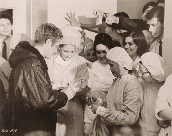 Appraisal: A photograph of Steve McQueen with medical staff from the