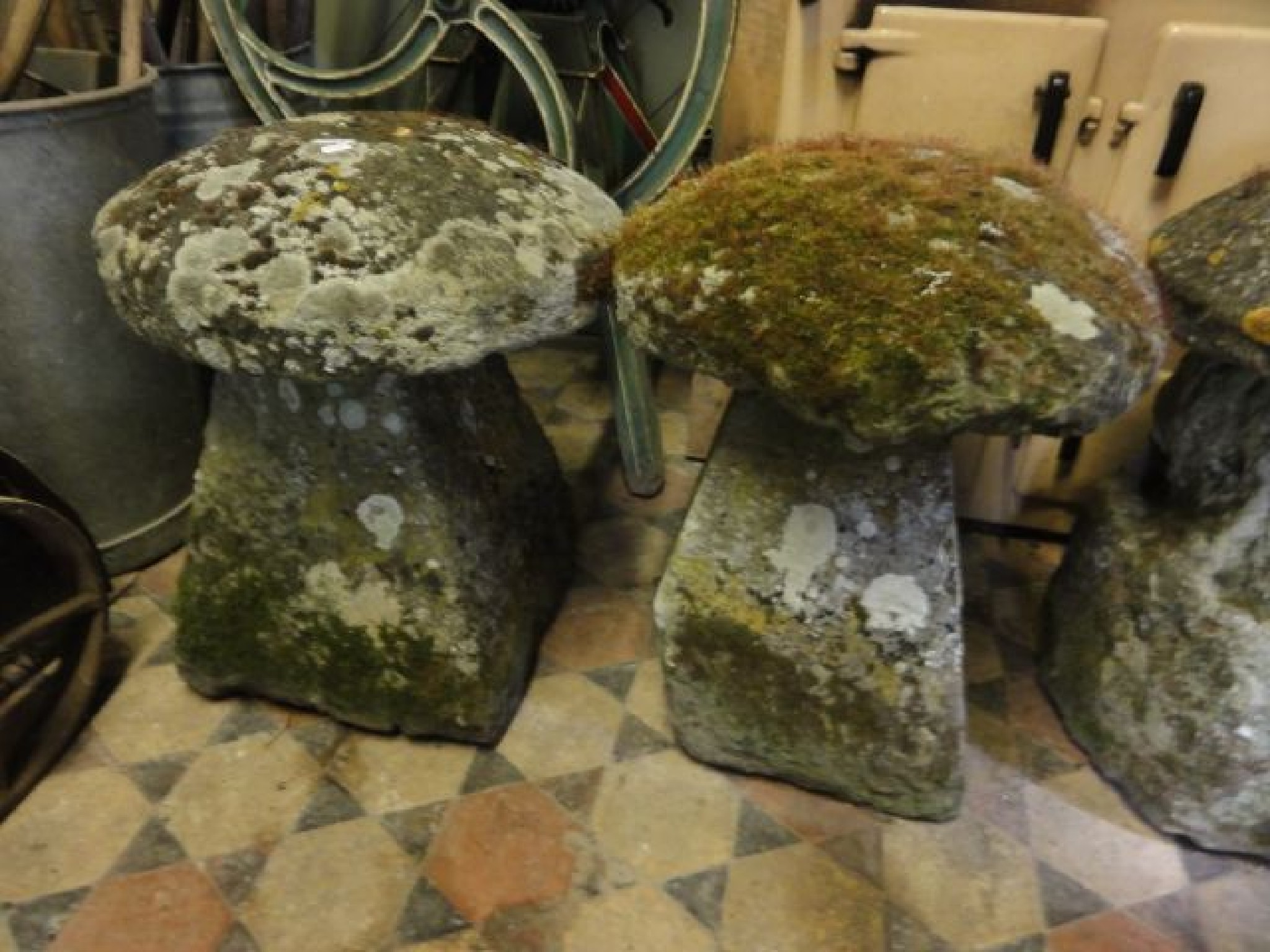 Appraisal: A near pair of weathered natural stone staddle stones and