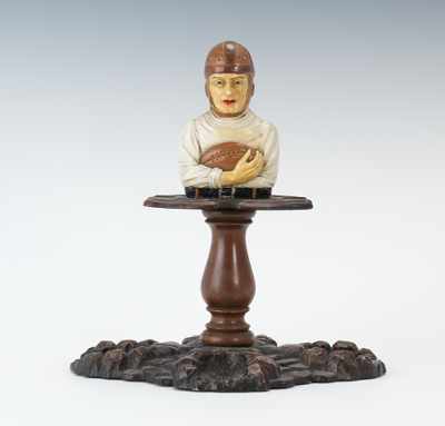 Appraisal: A Football Figural Pipe Rest Comprised of molded base of