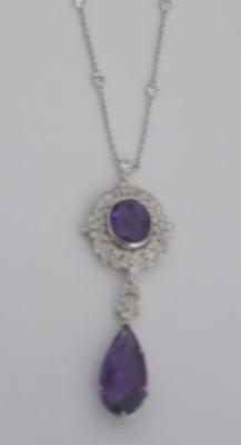 Appraisal: AN AMETHYST AND DIAMOND PENDANT comprising oval cut amethyst set