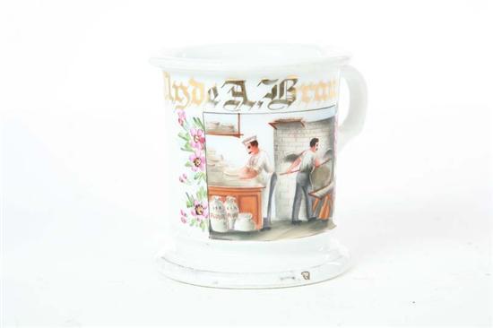 Appraisal: OCCUPATIONAL SHAVING MUG Polychrome bakery scene flanked by flowers on