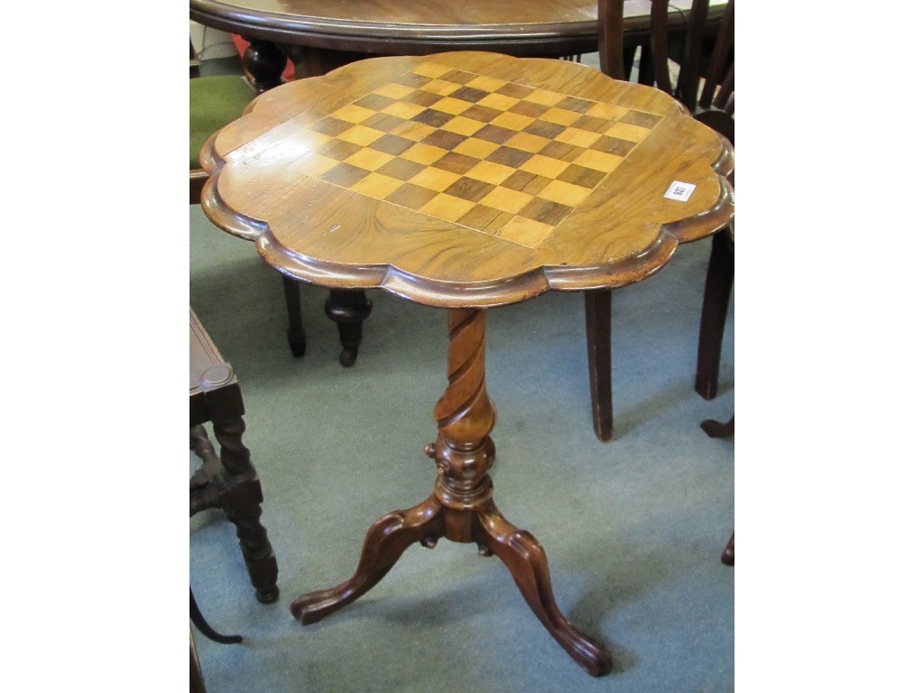 Appraisal: Victorian walnut chess table raised on a carved tripod base