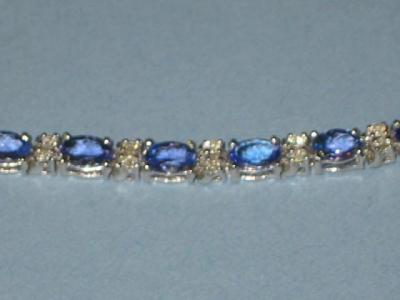 Appraisal: A TANZANITE AND DIAMOND BRACELET comprising oval cut tanzanite claw