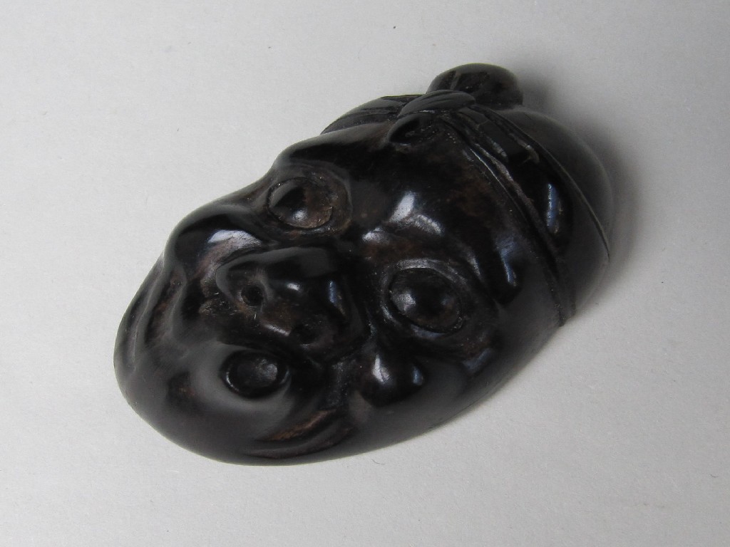 Appraisal: A netsuke carved as a grotesque mask cm high