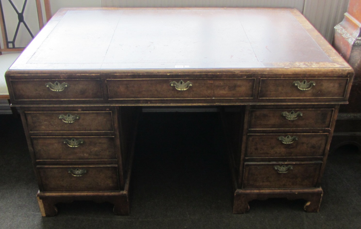 Appraisal: An th century style walnut pedestal desk with nine drawers