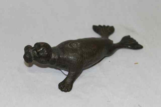 Appraisal: A BRONZE PROBABLY JAPANESE MODEL of a seal with green