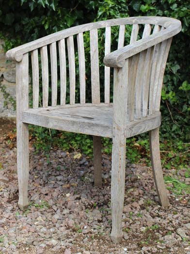 Appraisal: A TEAK GARDEN CHAIR with rounded back lathe supports standing