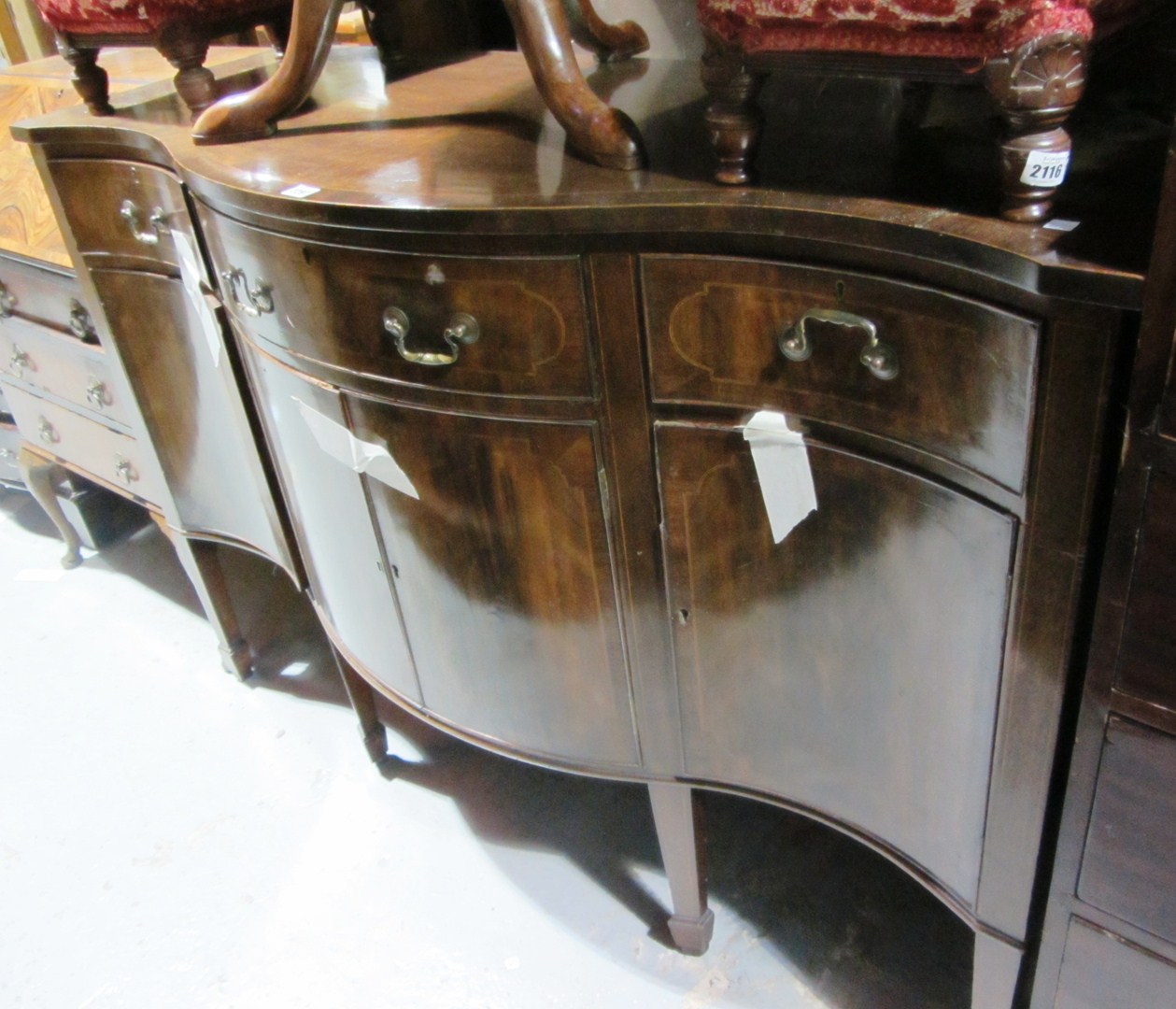 Appraisal: An th century style mahogany serpentine sideboard on spade feet