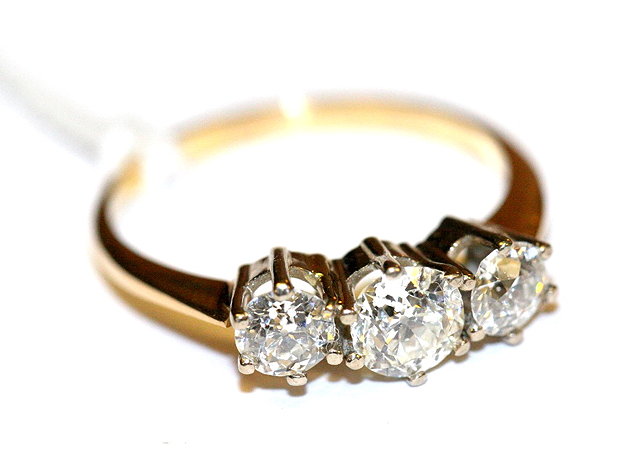 Appraisal: A GRADUATED THREE STONE DIAMOND SET DRESS RING with brilliant