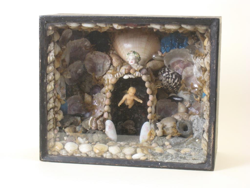 Appraisal: A glazed shell 'Grotto' having arch with hanging Cherub in