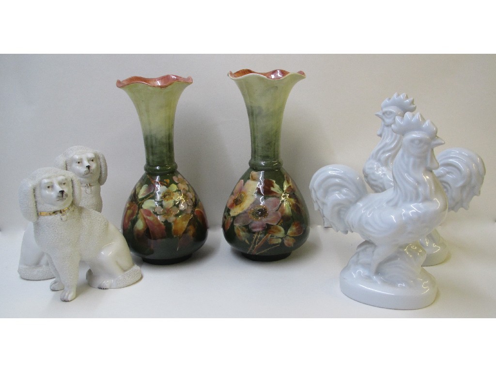 Appraisal: A pair of English pottery vases painted with wild roses