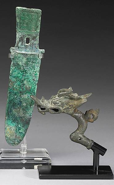 Appraisal: Three metal decorations One a Zhou Dynasty bronze knife burial