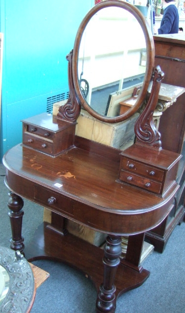 Appraisal: A Victorian mahogany Duchess style dressing table the oval mirror