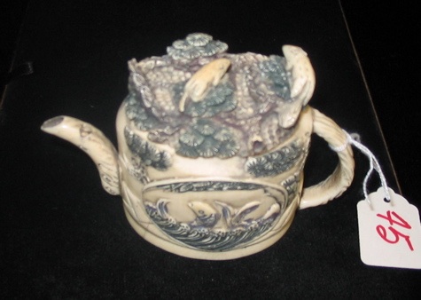 Appraisal: A CHINESE CARVED IVORY MINIATURE TEAPOT having scrimshawed decoration of