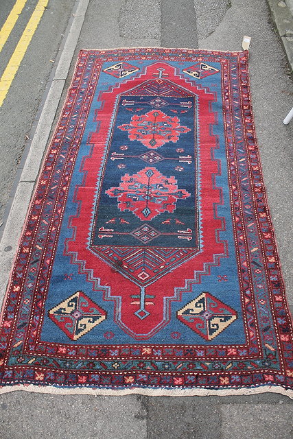 Appraisal: A HAMADAN BLUE GROUND RUG with central panel within a