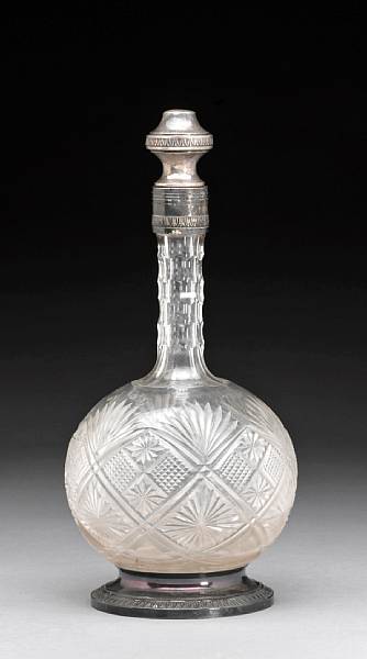 Appraisal: A French cut glass wine decanter with standard silver foot