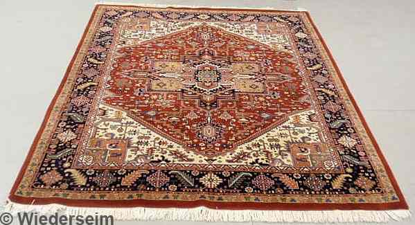 Appraisal: Heriz style oriental carpet red field and overall geometric patterns