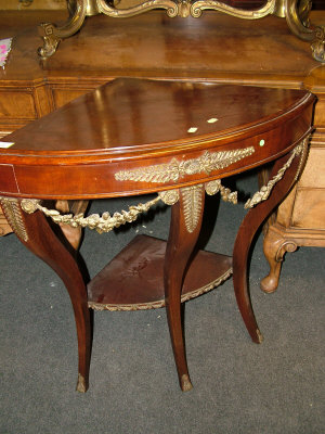 Appraisal: A nd Empire style mahogany corner table with pierced foliate