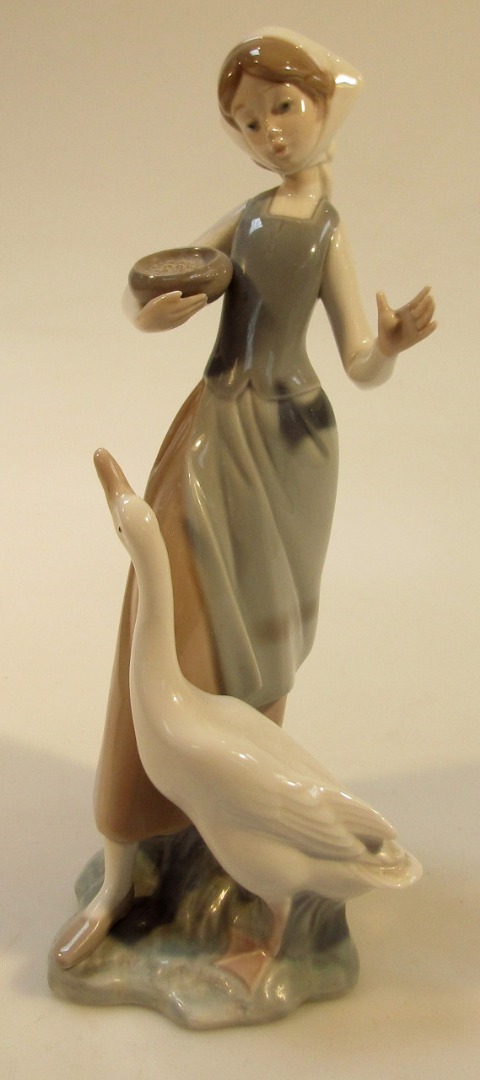 Appraisal: A thC Lladro figure of a farmer girl holding a