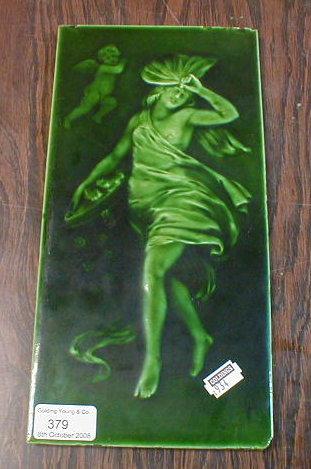 Appraisal: A green glazed picture tile of a classical pinnacle figure