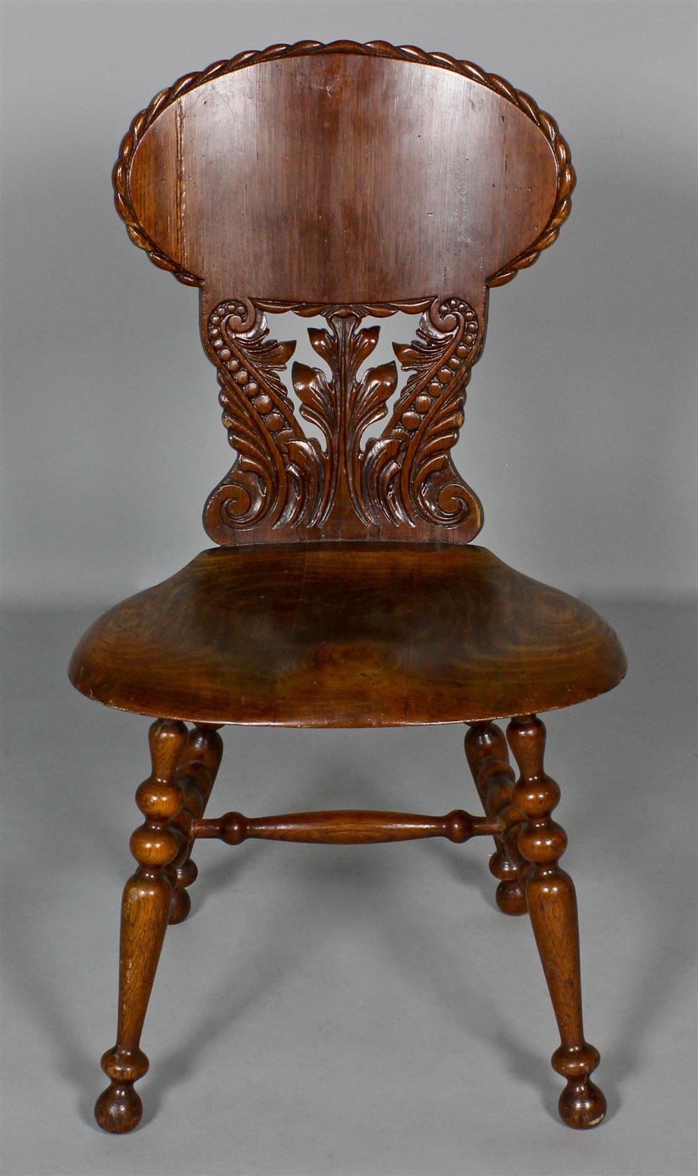 Appraisal: ENGLISH CARVED AND TURNED HALL CHAIR the oval upper back