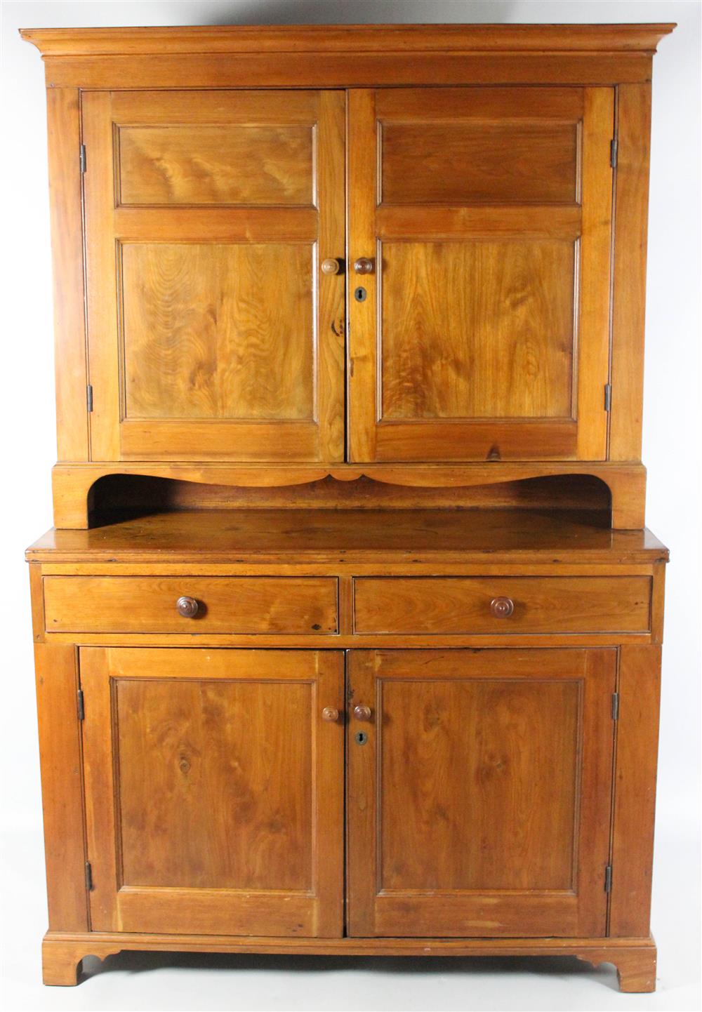 Appraisal: PENNSYLVANIA CHERRYWOOD STEP BACK CUPBOARD having an outset molded cornice