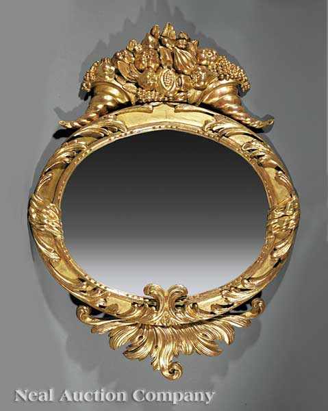 Appraisal: An American Classical Carved Giltwood Mirror th c oval mirror