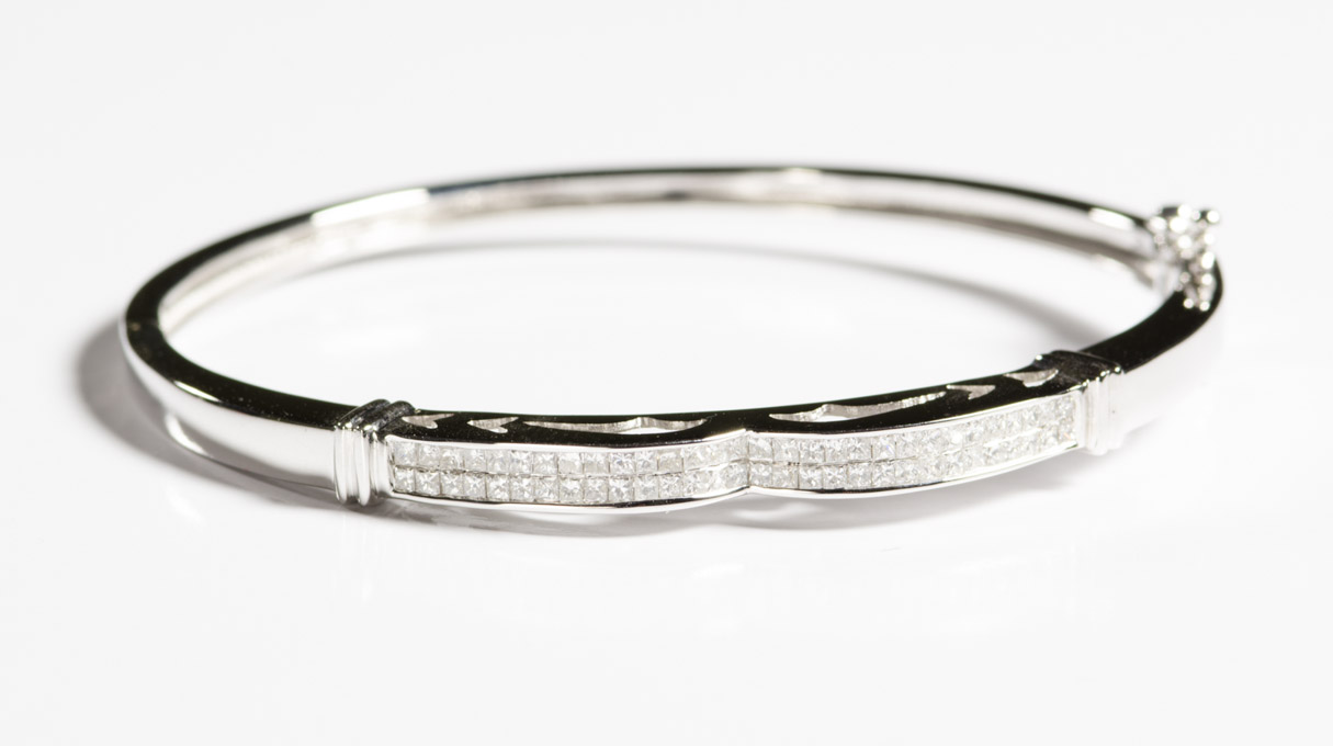 Appraisal: DIAMOND AND FOURTEEN KARAT WHITE GOLD BANGLE set with princess-cut