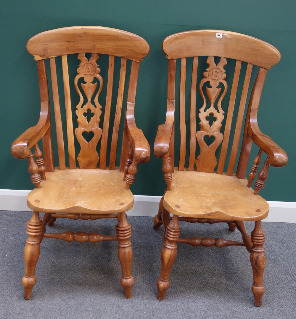 Appraisal: A pair of yew wood kitchen scullery armchairs with shaped