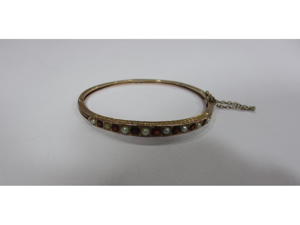 Appraisal: Victorian carat gold garnet and pearl set bangle