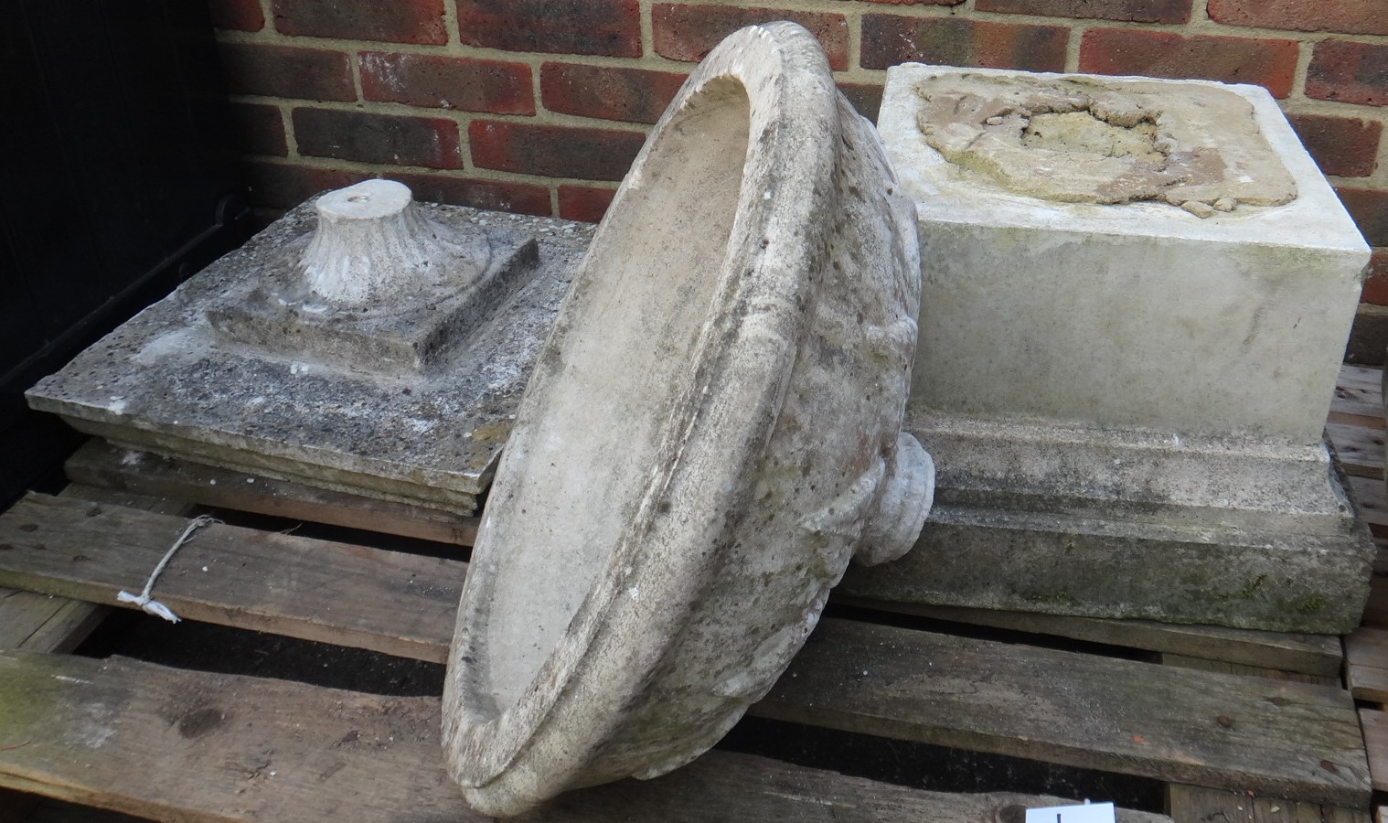 Appraisal: A reconstituted stone planter on fluted soccle and stepped square