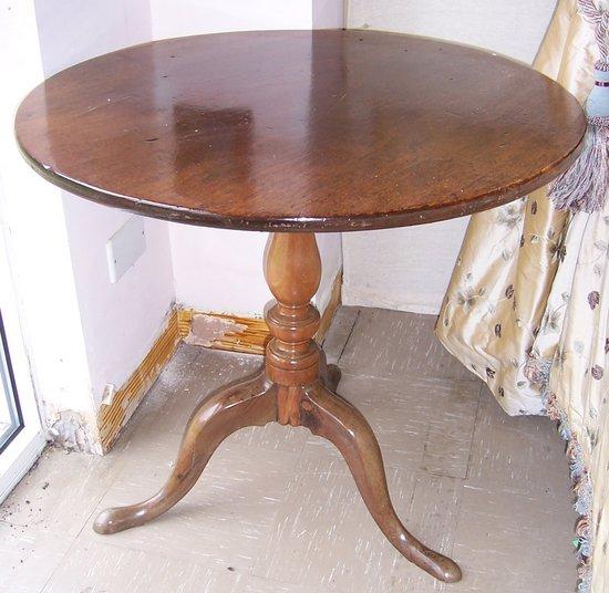 Appraisal: A George III mahogany tripod table the circular one-plank top