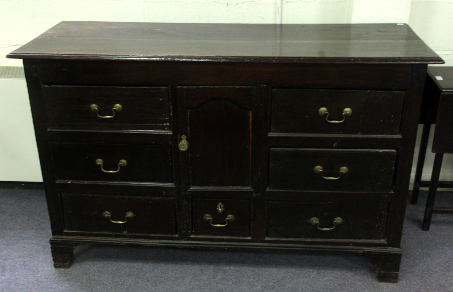 Appraisal: A th Century oak dresser base fitted a central cupboard