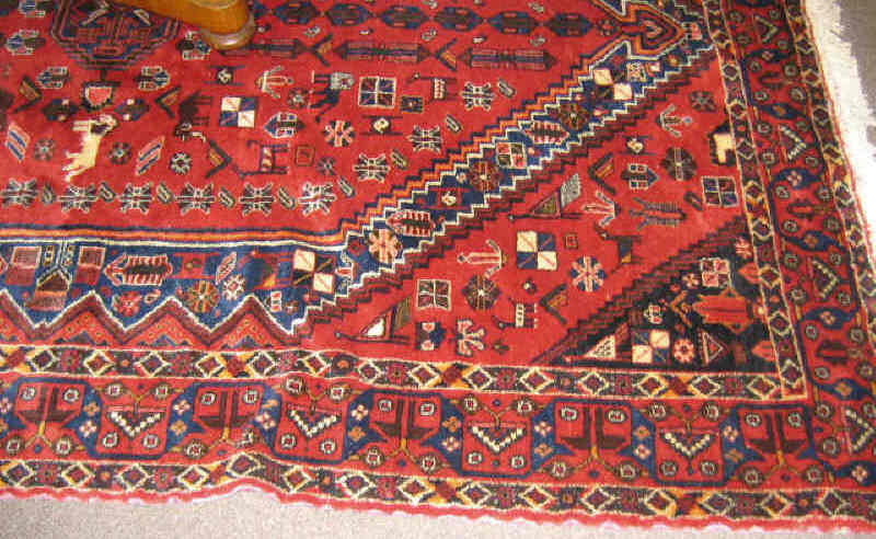 Appraisal: SHIRAZ DESIGN THROW RUG The rich red field shows a