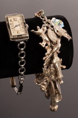 Appraisal: A silver charm bracelet hung with a wide variety of