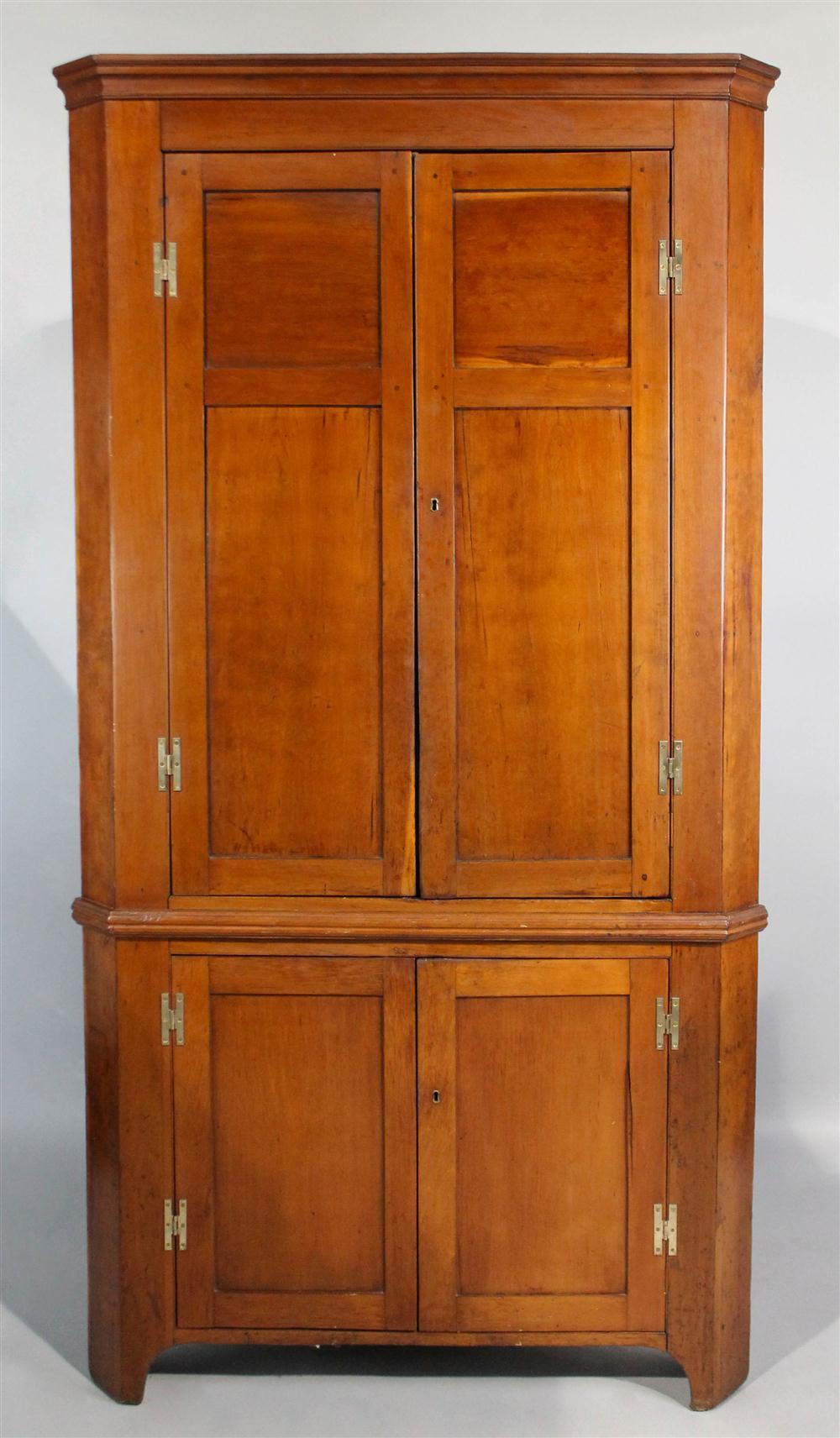 Appraisal: FEDERAL CHERRYWOOD PANELED DOOR CORNER CUPBOARD having an outset molded