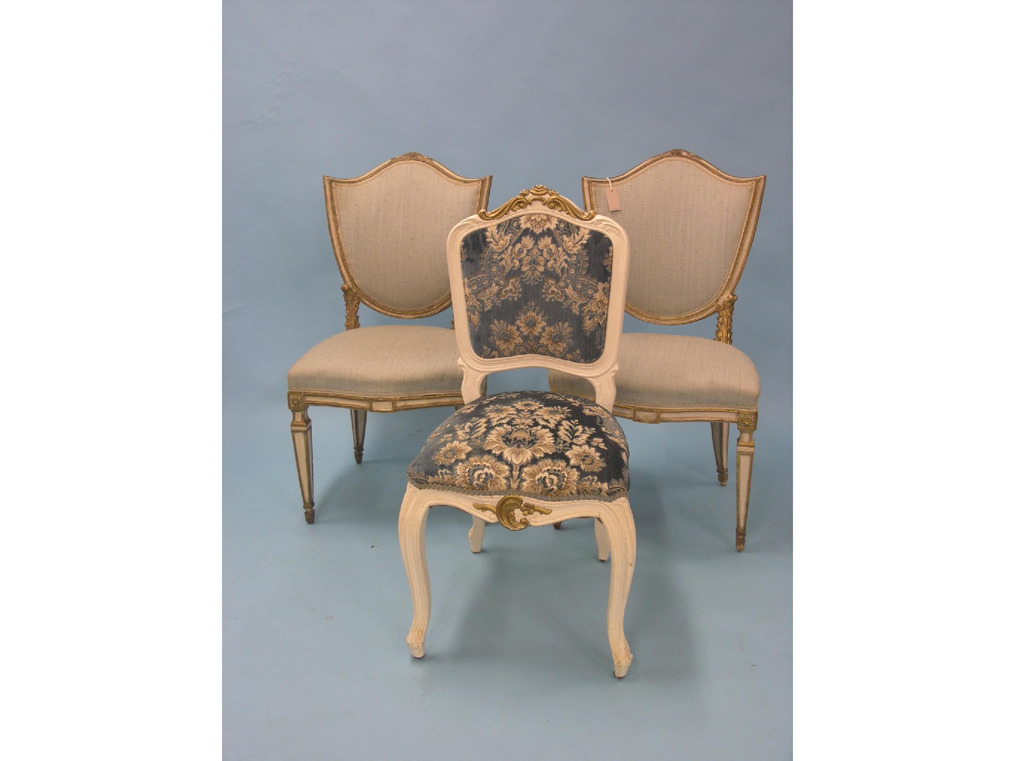 Appraisal: A pair of cream and gilt-finished dining chairs with upholstered