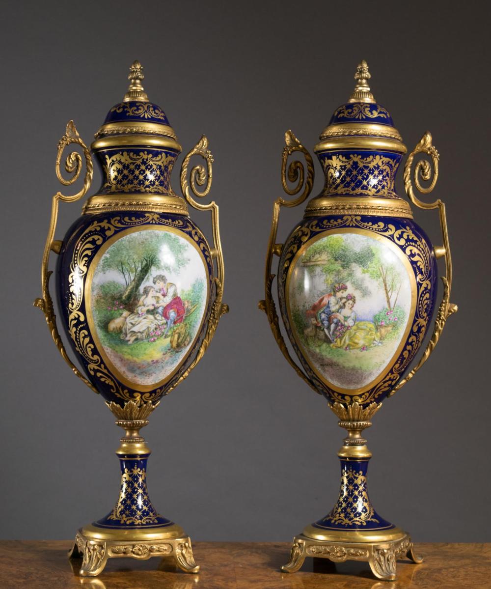 Appraisal: PAIR OF SEVRES STYLE PORCELAIN GILT METAL URNS each featuring