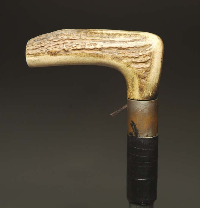 Appraisal: ANTIQUE CANE GUN The cane fitted with a stag antler