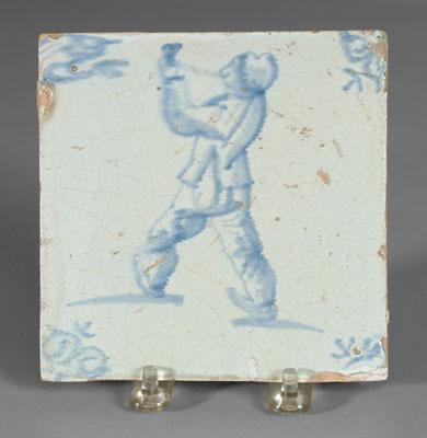 Appraisal: Dutch tile man smoking ox head corners flanking figure of