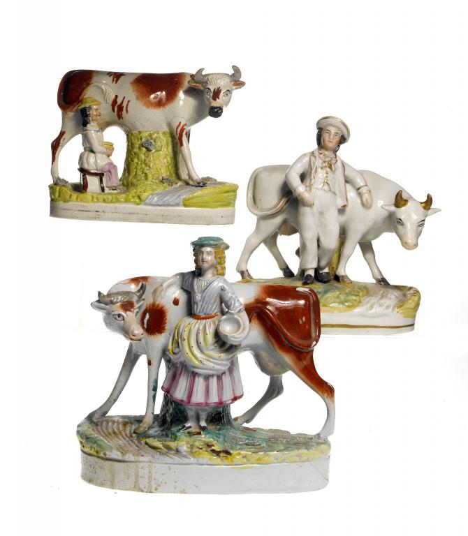 Appraisal: THREE STAFFORDSHIRE EARTHENWARE MILKMAID OR COW HERD AND COW GROUPS