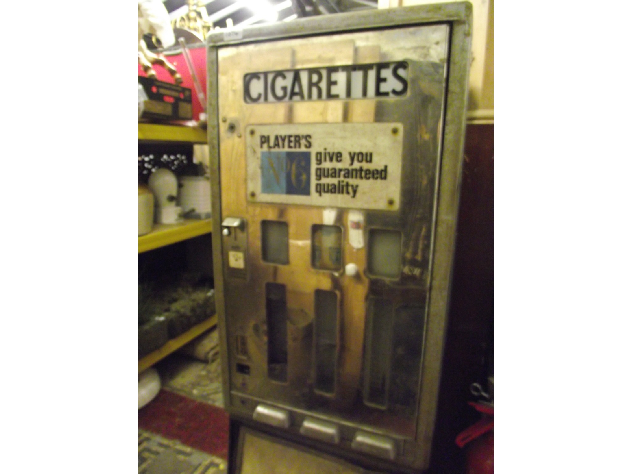 Appraisal: A vintage coin operated cigarette dispenser raised on a tubular