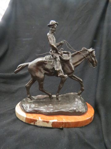 Appraisal: Bronze Statue of a Cowboy on Horseback after C M